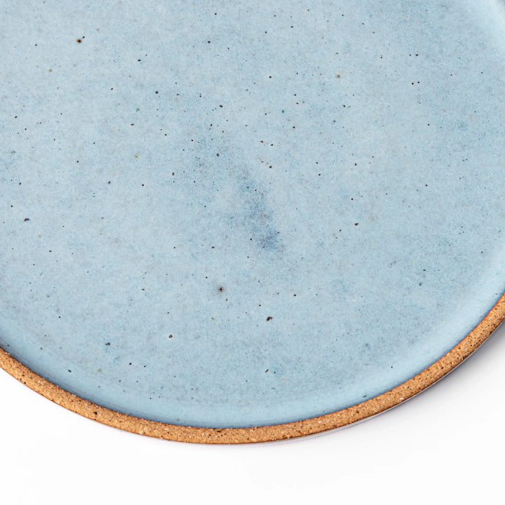 Terracotta blue ceramic dessert plate with rustic brown rim, handcrafted in Japan for serving cake, pastry, appetizers, or everyday meals.