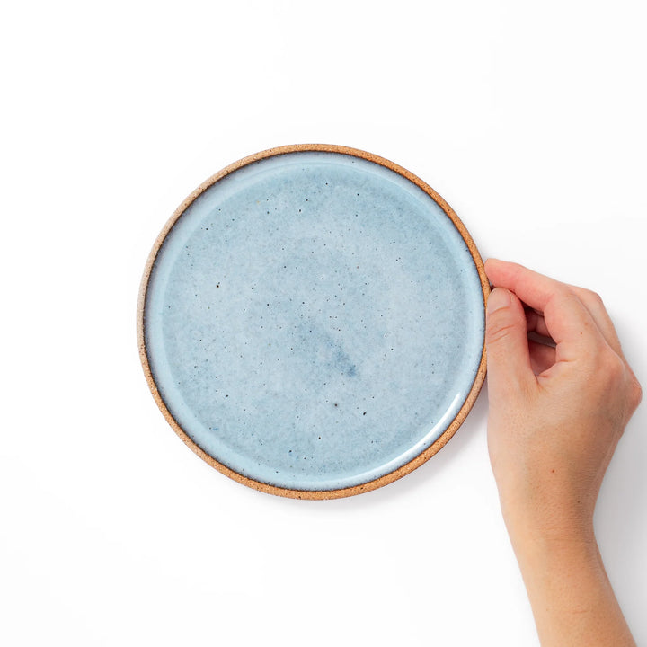 Terracotta blue ceramic dessert plate with rustic brown rim, handcrafted in Japan for serving cake, pastry, appetizers, or everyday meals.