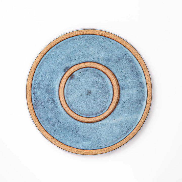 Terracotta blue ceramic dinner plate with rustic brown rim, handcrafted in Japan for serving main dishes, pasta, or everyday meals.