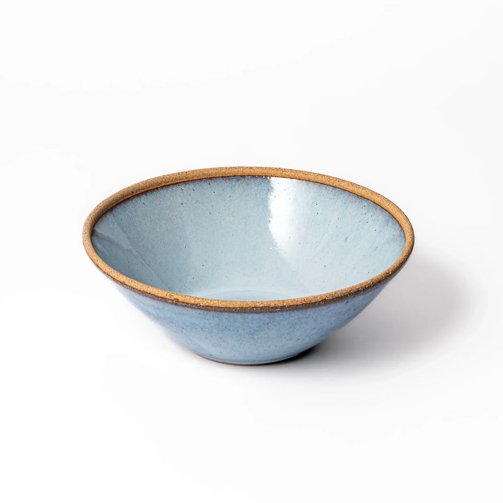 Terracotta blue ceramic pasta bowl with rustic brown rim, handcrafted in Japan for serving pasta, curry, salad, or versatile everyday meals.