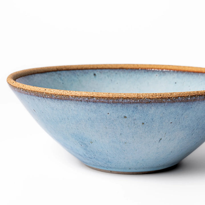 Terracotta blue ceramic pasta bowl with rustic brown rim, handcrafted in Japan for serving pasta, curry, salad, or versatile everyday meals.