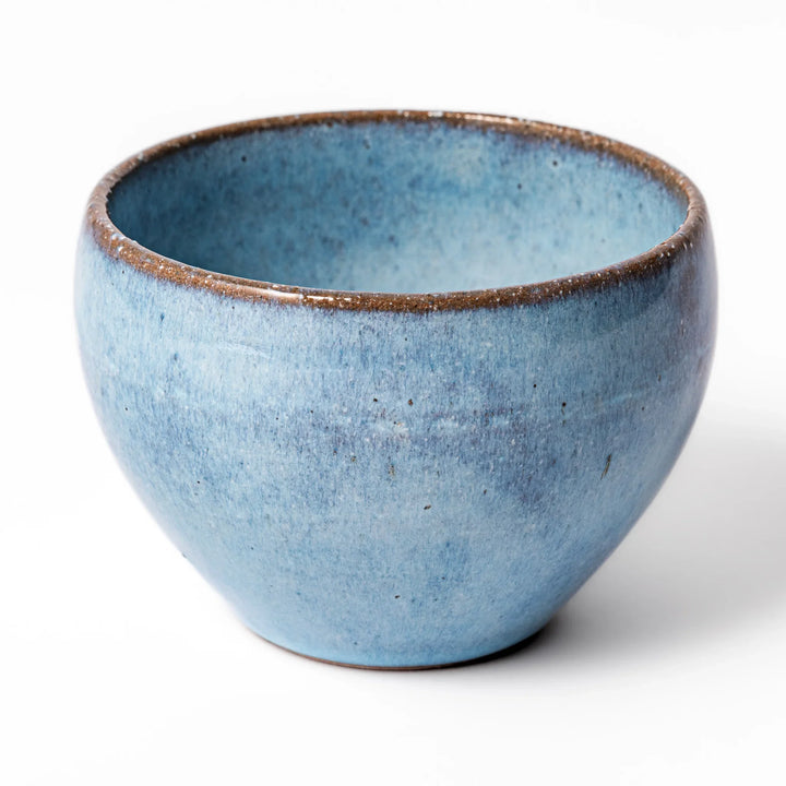 Terracotta blue ceramic tea cup with rustic brown rim, handcrafted in Japan for serving green tea, coffee, or everyday hot drinks.