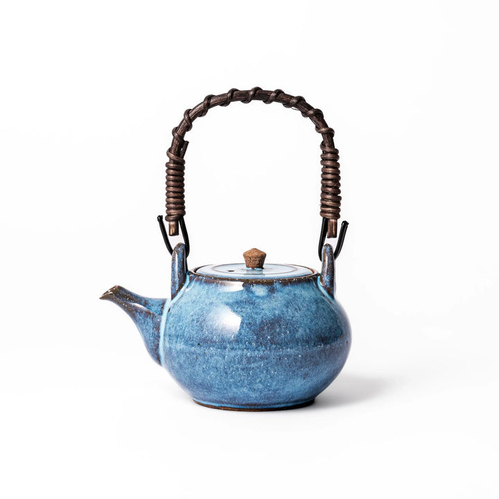 Terracotta blue ceramic teapot with rustic brown rim and woven metal handle, handcrafted in Japan for serving green tea or everyday brewing.