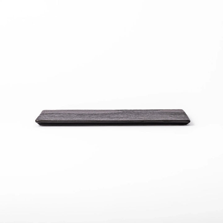 Textured black ceramic dinner plate with ridged woodgrain and matte-gloss accents, ideal for refined Japanese dining and modern presentation.