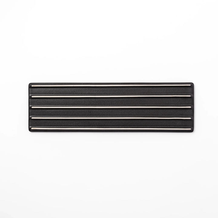 Rectangular black ceramic serving plate with a subtle ridged woodgrain texture, perfect for stylish Japanese meals and contemporary plating.