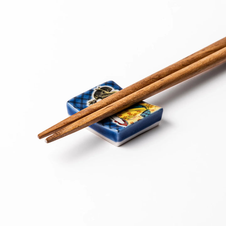 Rectangular Japanese ceramic chopstick rest featuring an elegant courtesan in traditional kimono, inspired by Utamaro’s ukiyo-e artistry, perfect for table decor.