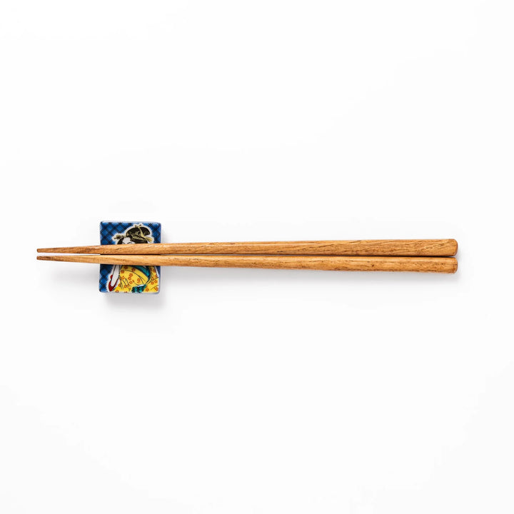 Rectangular Japanese ceramic chopstick rest featuring an elegant courtesan in traditional kimono, inspired by Utamaro’s ukiyo-e artistry, perfect for table decor.