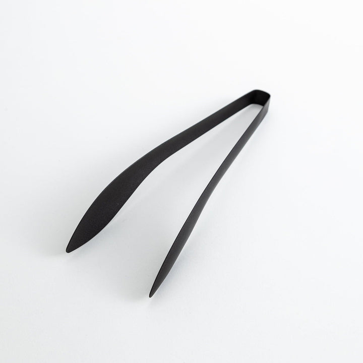 Sleek, matte black serving tongs with smooth curves, ideal for precise handling of small foods.