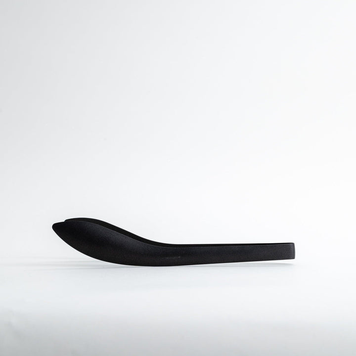 Sleek, matte black serving tongs with smooth curves, ideal for precise handling of small foods.