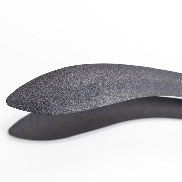 Sleek, matte black serving tongs with smooth curves, ideal for precise handling of small foods.
