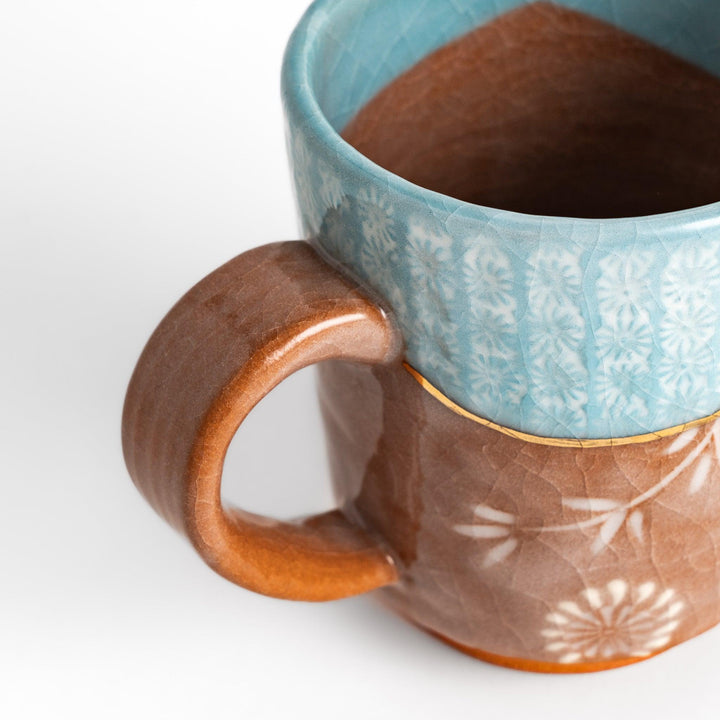 Azure floral elegance mug with delicate flower patterns and gold detailing on the rim, perfect for enjoying hot beverages in style.
