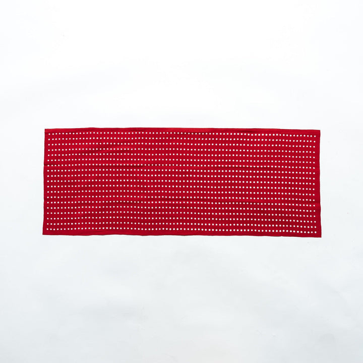 Red tenugui fully laid out, featuring white bean dot patterns in rows.