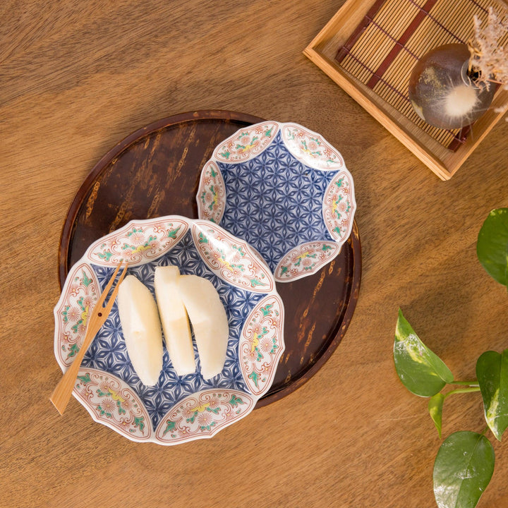 Two Bellflower Hemp Star dishes with a blue geometric design and orange floral details, placed on a wooden tray.