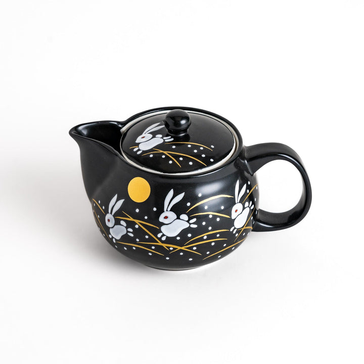 Black teapot featuring white rabbits, golden grasses, and a full moon design, inspired by traditional Japanese autumn motifs.