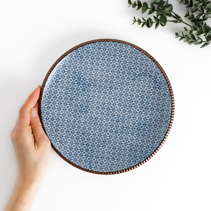 Blue and white patterned Dinner Plate featuring a delicate floral design and a brown textured rim, perfect for elegant dining settings.