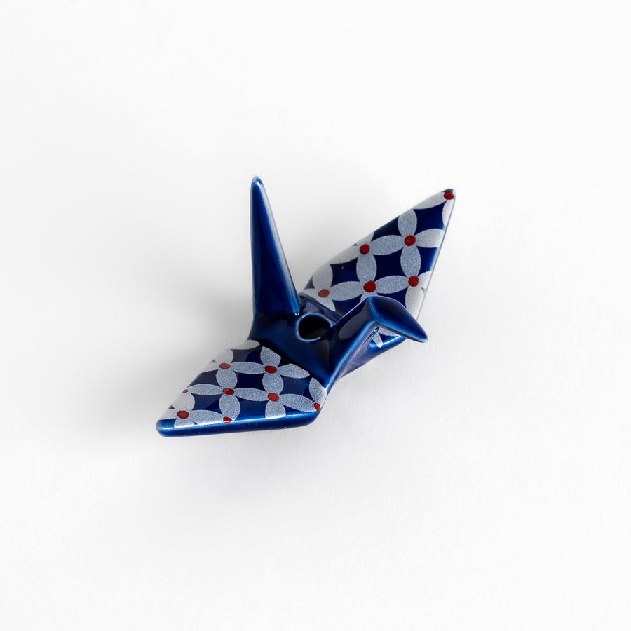 Blue origami crane incense holder with a geometric silver and red pattern, adding a unique, artistic touch to your space.