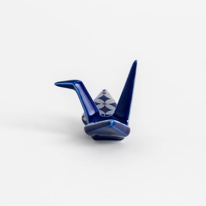 Blue origami crane incense holder with a geometric silver and red pattern, adding a unique, artistic touch to your space.