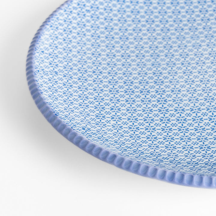 Blue and white floral patterned Dinner Plate with a subtle striped rim, offering an elegant touch for refined dining presentations.