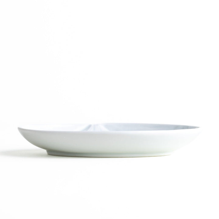 A round celadon dessert plate with a subtle raised pattern depicting Mount Fuji and surrounding nature, with a smooth, glossy finish.