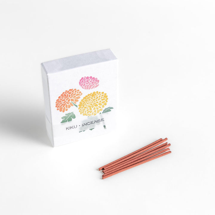 Incense featuring warm reddish-brown sticks in a box decorated with vibrant chrysanthemum flowers, offering a refined floral aroma for a calming atmosphere.