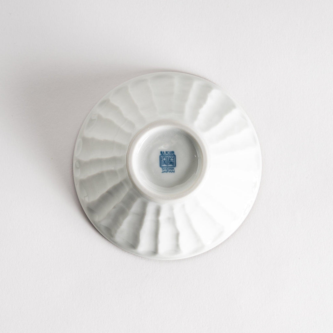 A small fluted bowl with a blue herringbone pattern on a white background.