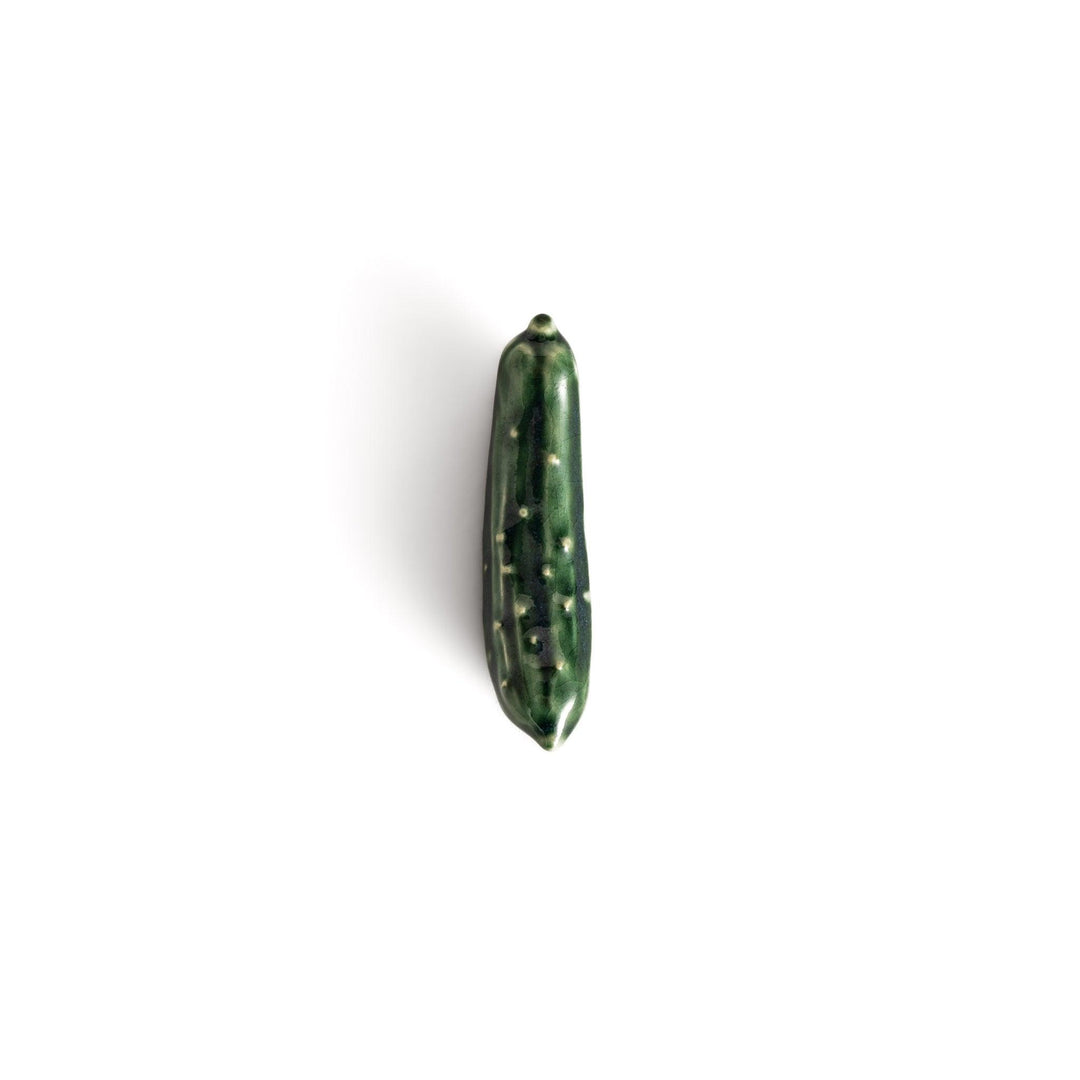 Glossy green ceramic cucumber chopstick rest with textured detailing, designed to add a playful and unique touch to your table setting.