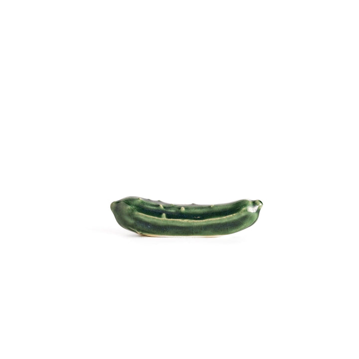 Glossy green ceramic cucumber chopstick rest with textured detailing, designed to add a playful and unique touch to your table setting.