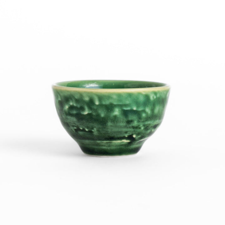Deep green ceramic sake cup with a glossy textured finish and rounded shape, ideal for enjoying traditional Japanese sake rituals.