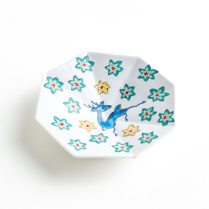 Octagonal plate with a blue deer surrounded by red and green floral patterns.