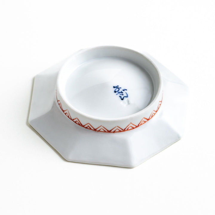 Octagonal plate with a blue deer surrounded by red and green floral patterns.