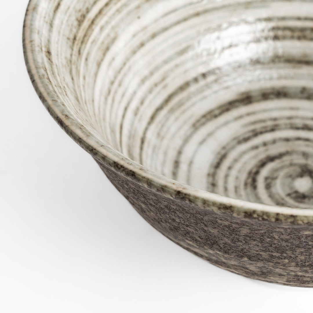 Textured ramen bowl with an earthy brown exterior, featuring a smooth white interior and a sturdy base for comfortable use.