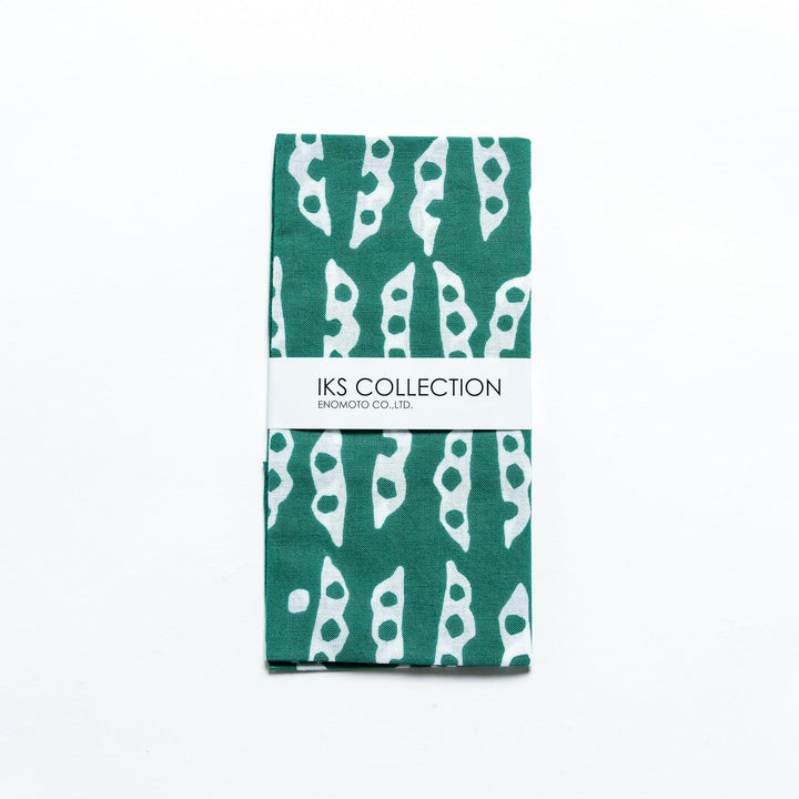 Folded green tenugui featuring edamame pod patterns, neatly wrapped with a product sleeve