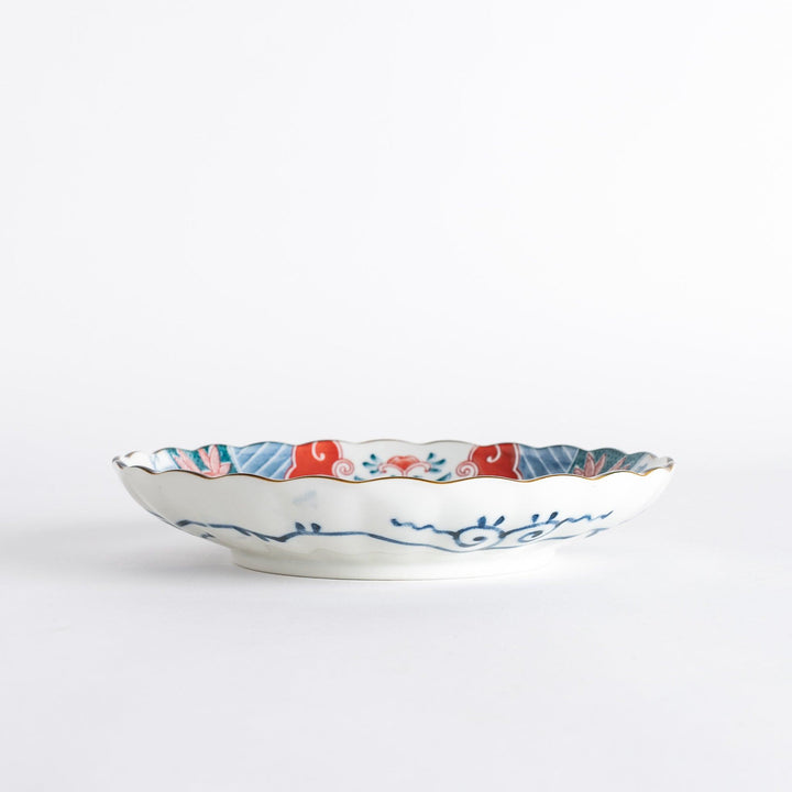 Profile view of the decorative plate, showing its depth and the vibrant colors of the design.