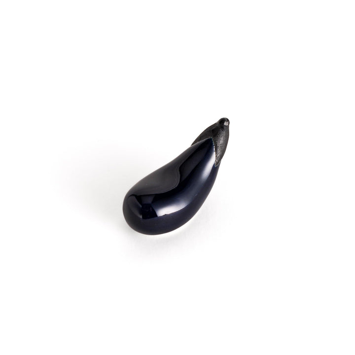 Glossy ceramic eggplant chopstick rest in deep purple with a textured black stem, perfect for adding a unique touch to your dining setting.