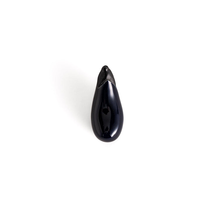 Glossy ceramic eggplant chopstick rest in deep purple with a textured black stem, perfect for adding a unique touch to your dining setting.