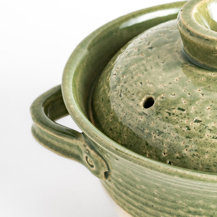 Emerald 3-Cup Rice Donabe, a traditional Japanese clay pot with a green glazed exterior and a round lid, perfect for cooking rice with authentic flavor.