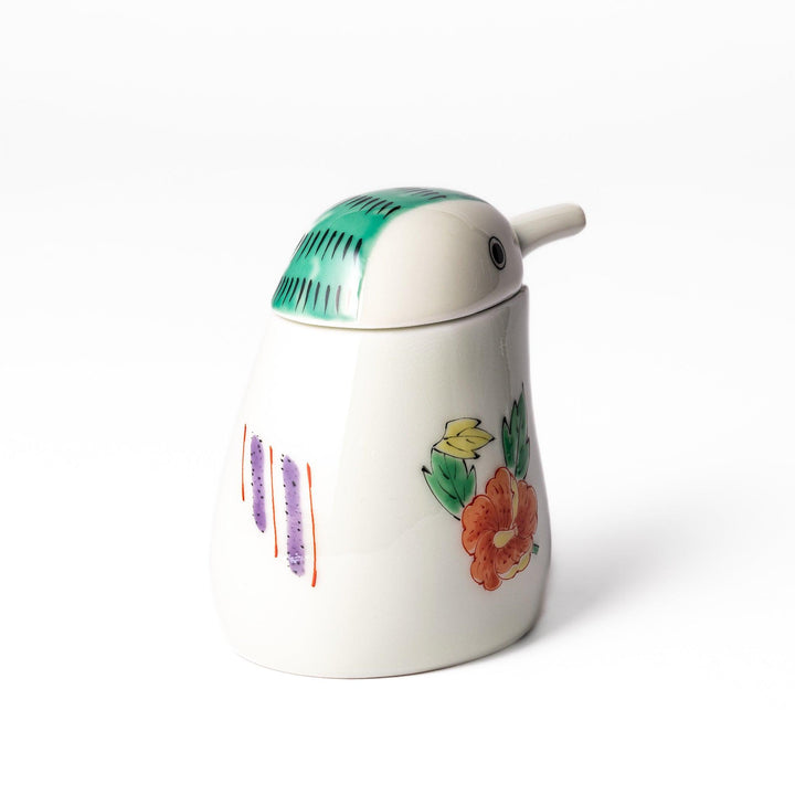 A bird-shaped soy sauce dispenser featuring a traditional floral design in red, green, and orange.