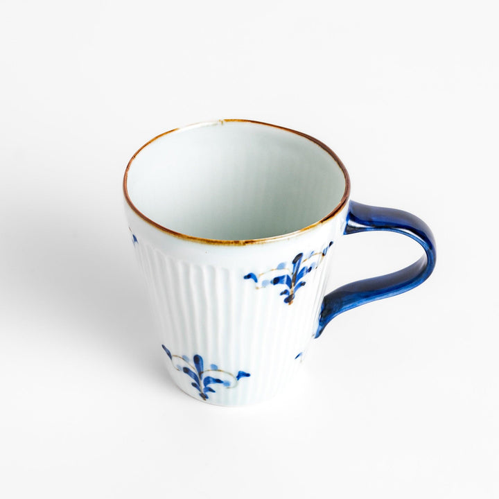 Elegant floral leaves mug with blue floral patterns and a blue handle, featuring a delicate ribbed design and gold trim for a classic, refined look.