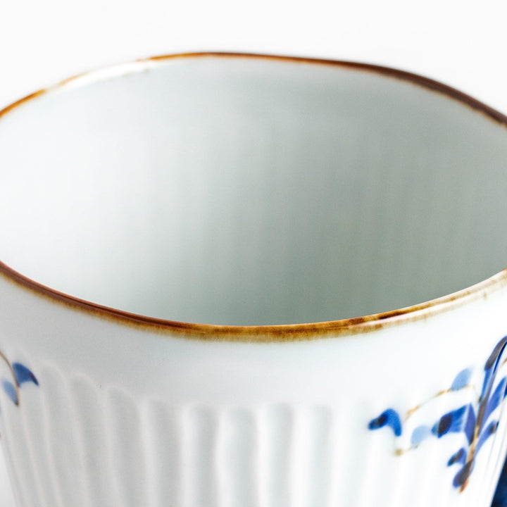 Elegant floral leaves mug with blue floral patterns and a blue handle, featuring a delicate ribbed design and gold trim for a classic, refined look.