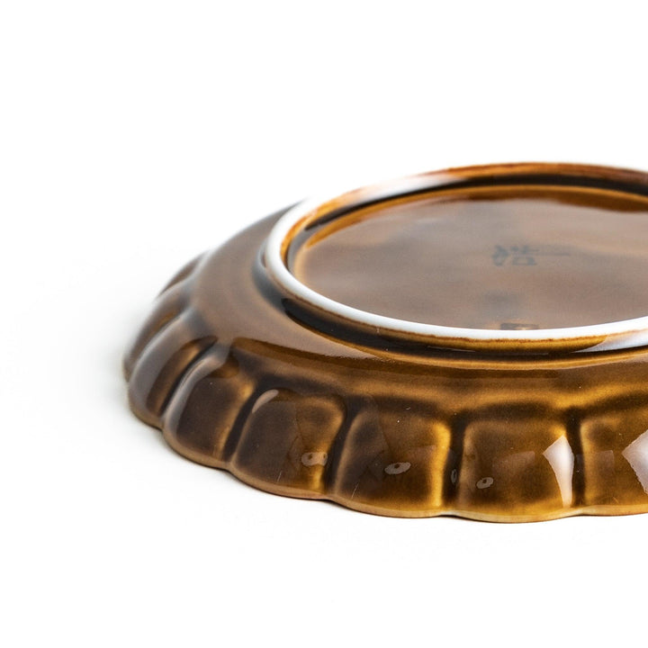 Round, dark brown or olive colored dessert plate with a scalloped edge, featuring a glossy finish.