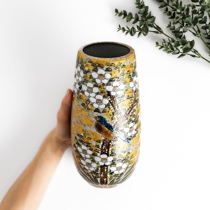 Flower Vase featuring a hand-painted design of blooming flowers and a bird perched on a tree, with warm golden and green tones.