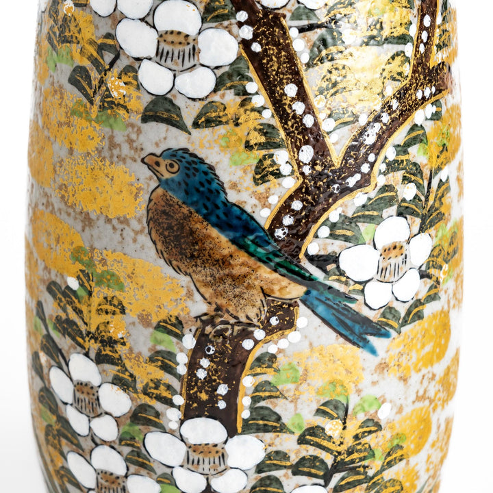 Flower Vase featuring a hand-painted design of blooming flowers and a bird perched on a tree, with warm golden and green tones.