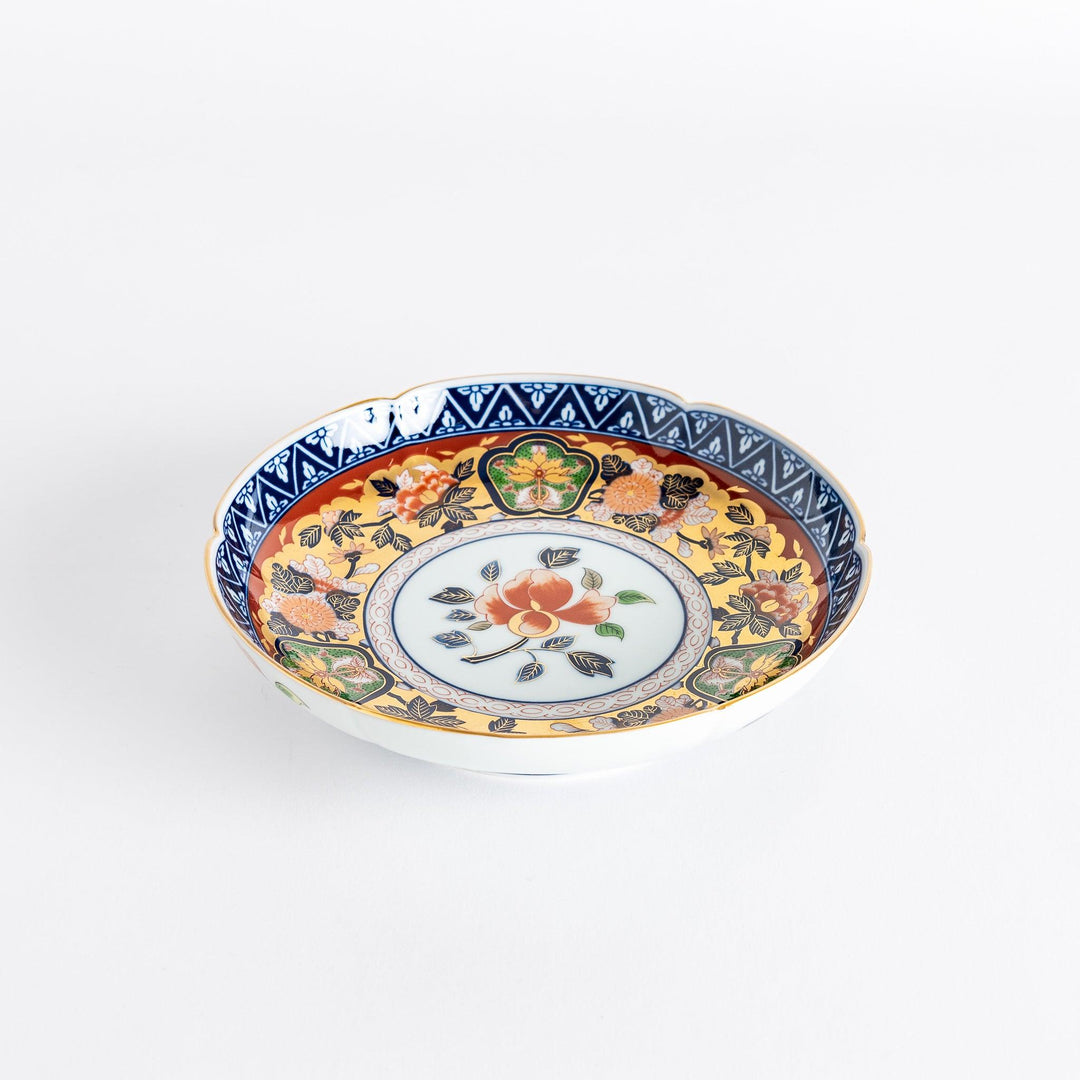 A floral salad plate with intricate gold detailing, showcasing a vibrant red flower at its center surrounded by intricate patterns in green, blue, and gold.