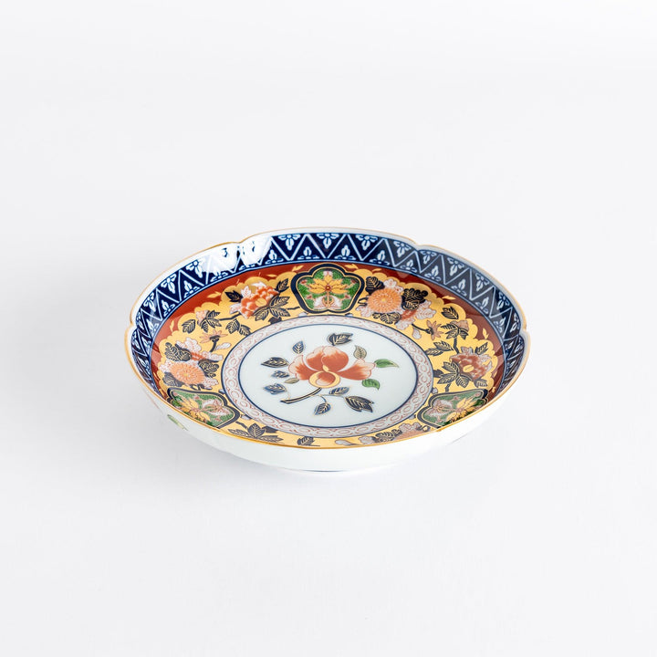 A floral salad plate with intricate gold detailing, showcasing a vibrant red flower at its center surrounded by intricate patterns in green, blue, and gold.