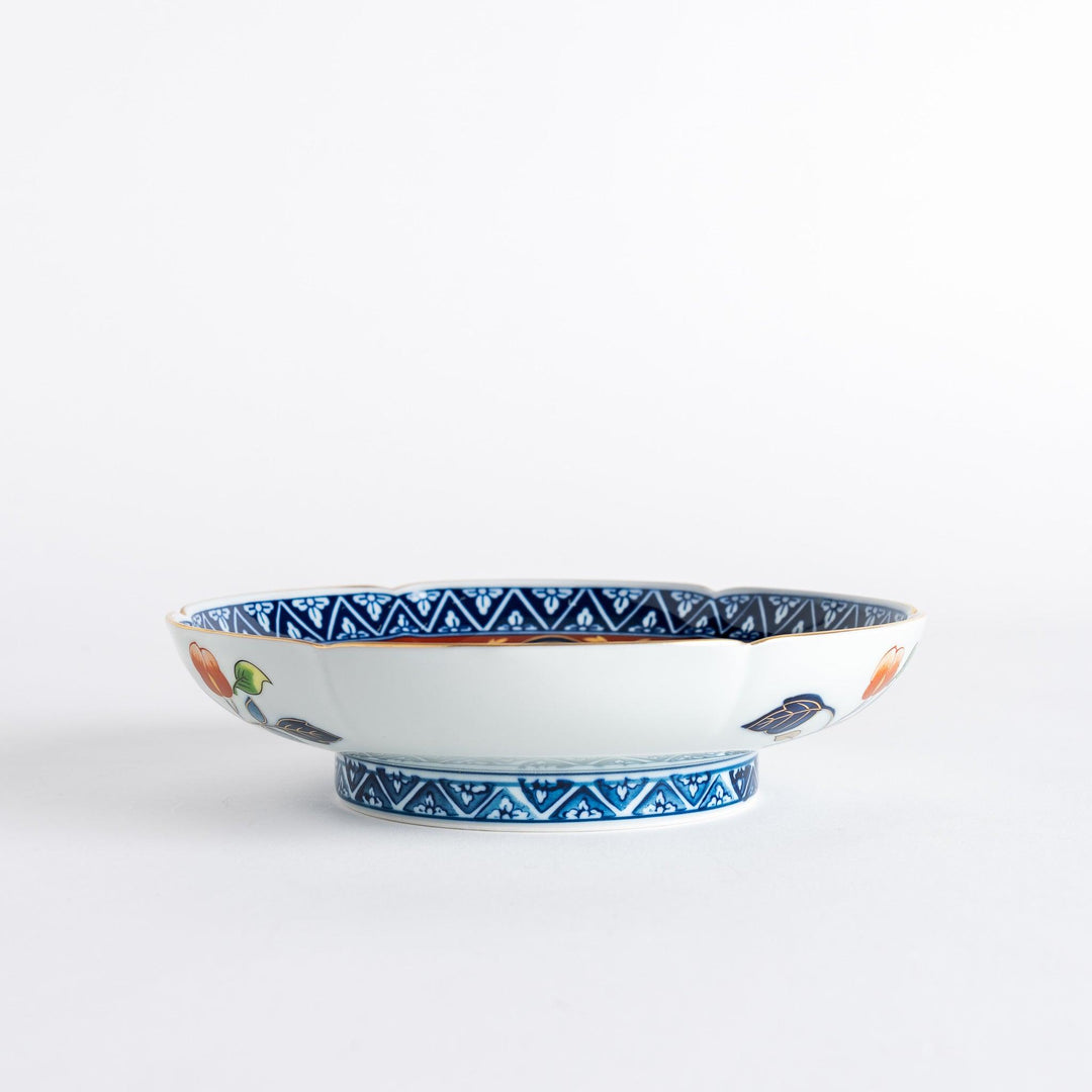 A floral salad plate with intricate gold detailing, showcasing a vibrant red flower at its center surrounded by intricate patterns in green, blue, and gold.