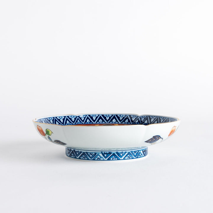 A floral salad plate with intricate gold detailing, showcasing a vibrant red flower at its center surrounded by intricate patterns in green, blue, and gold.