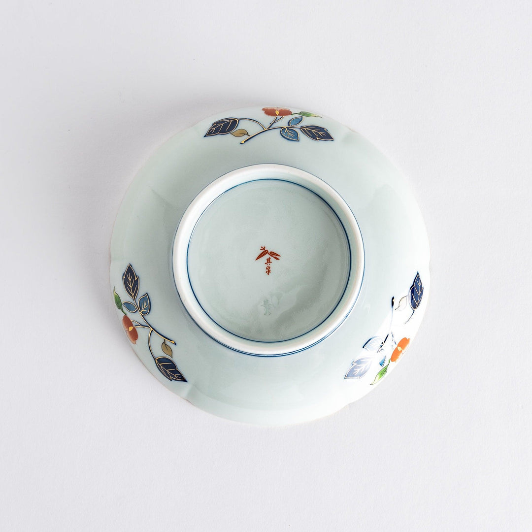 A floral salad plate with intricate gold detailing, showcasing a vibrant red flower at its center surrounded by intricate patterns in green, blue, and gold.