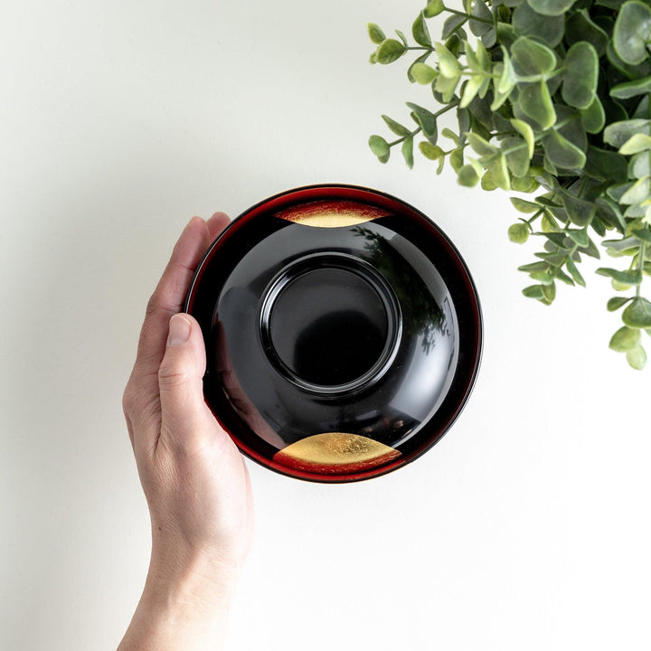 Traditional black lacquer bowl with a golden moon motif on the exterior, featuring a smooth, glossy finish.