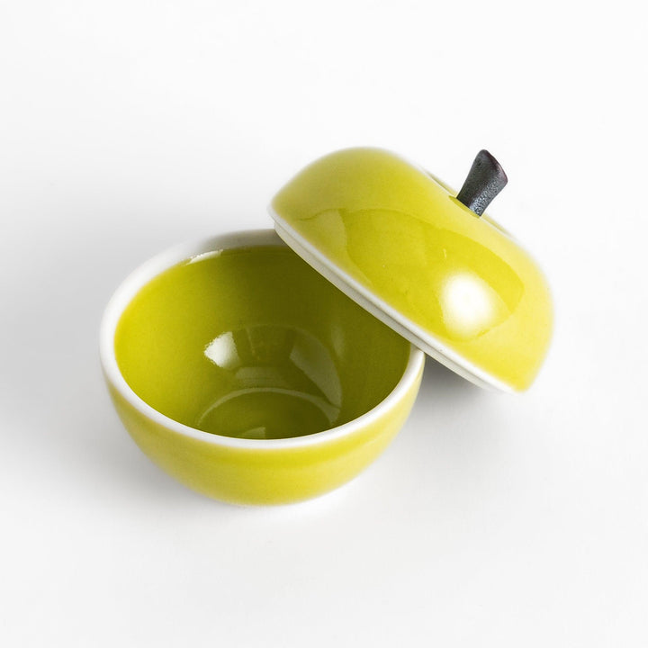 Green Apple Lidded Condiment Bowl, a charming ceramic bowl with a glossy green finish and a small black stem, perfect for serving sauces and condiments.