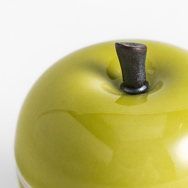 Green Apple Lidded Condiment Bowl, a charming ceramic bowl with a glossy green finish and a small black stem, perfect for serving sauces and condiments.